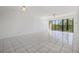 A bright, spacious living room with large sliding glass doors and tile flooring at 2700 Cove Cay Dr # 4-B, Clearwater, FL 33760