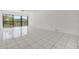 Bright living room with sliding doors to balcony and tile flooring at 2700 Cove Cay Dr # 4-B, Clearwater, FL 33760
