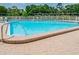 Community pool with pristine blue water and well-maintained deck at 2700 Cove Cay Dr # 4-B, Clearwater, FL 33760
