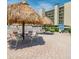 Relaxing poolside with a tiki umbrella, lounge chairs, and tables at 2700 Cove Cay Dr # 4-B, Clearwater, FL 33760