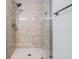 Tiled shower with glass door, shower head, and built-in niche at 2700 Cove Cay Dr # 4-B, Clearwater, FL 33760