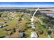 Discover this charming property from an aerial view, nestled amidst lush trees on a spacious lot at 3307 Fox Ridge Blvd, Wesley Chapel, FL 33543