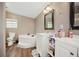 Bathroom featuring dual sinks, a soaking tub, and modern fixtures, creating a relaxing retreat at 3307 Fox Ridge Blvd, Wesley Chapel, FL 33543