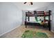 bedroom featuring a bunk bed, carpet flooring and a playful rug at 3307 Fox Ridge Blvd, Wesley Chapel, FL 33543