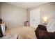 Bedroom features a comfortable chair and well-lit closet area, perfect for relaxation at 3307 Fox Ridge Blvd, Wesley Chapel, FL 33543