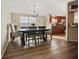 Well-lit dining room with wood floors and a view of the kitchen at 3307 Fox Ridge Blvd, Wesley Chapel, FL 33543