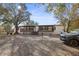 Exterior view showcasing the home with a front porch and gravel landscaping at 3307 Fox Ridge Blvd, Wesley Chapel, FL 33543