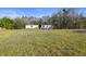 A charming single-story white home with a playset and a spacious grassy front yard at 3307 Fox Ridge Blvd, Wesley Chapel, FL 33543
