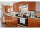 Well-equipped kitchen featuring wood cabinets, modern appliances, and stylish countertops at 3307 Fox Ridge Blvd, Wesley Chapel, FL 33543
