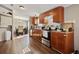 Open kitchen and dining area with hardwood floors and modern cabinetry at 3307 Fox Ridge Blvd, Wesley Chapel, FL 33543