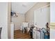 Laundry room features a laundry sink, shelving, and a washer at 3307 Fox Ridge Blvd, Wesley Chapel, FL 33543
