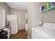 Spacious laundry area with washer, shelving, and a refrigerator at 3307 Fox Ridge Blvd, Wesley Chapel, FL 33543