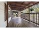 Inviting covered porch with wood flooring, perfect for outdoor lounging at 3307 Fox Ridge Blvd, Wesley Chapel, FL 33543