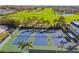 Aerial view of a community tennis courts surrounded by palm trees and green landscaping at 349 Shirley Ave, Belleair, FL 33756
