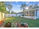 Well-maintained backyard with a white fence, lawn, and landscaping, creating a serene outdoor space at 349 Shirley Ave, Belleair, FL 33756