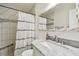 Bathroom featuring a marble vanity, tiled shower and decorative mirror at 349 Shirley Ave, Belleair, FL 33756
