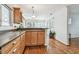 Bright kitchen featuring hardwood floors, wood cabinets, and a view into the dining area at 349 Shirley Ave, Belleair, FL 33756