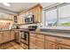Well-equipped kitchen featuring stainless steel appliances and wood cabinetry, and granite countertops at 349 Shirley Ave, Belleair, FL 33756