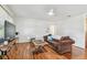 Bright living room with hardwood floors, ceiling fan, and a comfortable sofa at 349 Shirley Ave, Belleair, FL 33756