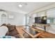 Spacious living room boasts hardwood floors, a large flat screen TV, and a ceiling fan at 349 Shirley Ave, Belleair, FL 33756