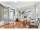 Bright sunroom with hardwood floors, large windows, and sliding glass doors leading to an enclosed patio at 349 Shirley Ave, Belleair, FL 33756