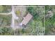An aerial view of the home shows the layout and surrounding landscape, a private wooded lot at 36246 Peak St, Zephyrhills, FL 33541