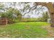 Lush backyard with a deck, fire pit and shed, ideal for outdoor entertaining and enjoying nature at 36246 Peak St, Zephyrhills, FL 33541