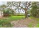 Expansive backyard with mature trees and green space, perfect for outdoor activities and relaxation at 36246 Peak St, Zephyrhills, FL 33541