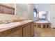 Bathroom featuring dual sinks, a large mirror, and a soaking tub for a spa-like experience at 36246 Peak St, Zephyrhills, FL 33541