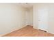 Cozy bedroom with wood-look flooring, ceiling fan, and two closets for ample storage options and convenience at 36246 Peak St, Zephyrhills, FL 33541