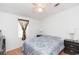 Bright bedroom with ceiling fan, bedside lamps, and two dressers, creating a cozy and functional space at 36246 Peak St, Zephyrhills, FL 33541