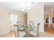 Cozy dining area featuring a glass-top table, upholstered chairs, and a stylish chandelier at 36246 Peak St, Zephyrhills, FL 33541