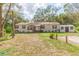 Well-kept single-story home with a tidy front yard and an auxiliary structure on the right side of the house at 36246 Peak St, Zephyrhills, FL 33541