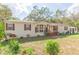 Charming single-story home featuring a covered front porch, neutral siding, and well-maintained landscaping at 36246 Peak St, Zephyrhills, FL 33541
