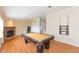 Entertaining game room with pool table, fireplace, and game machine, perfect for gatherings and memorable moments at 36246 Peak St, Zephyrhills, FL 33541