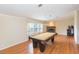 Spacious game room with billiard table, wood floors, fireplace, and window views for endless enjoyment and relaxation at 36246 Peak St, Zephyrhills, FL 33541