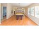 Large game room with billiards table, adjacent to dining area, features wood floors and large windows for natural light at 36246 Peak St, Zephyrhills, FL 33541