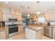 Modern kitchen featuring stainless steel appliances, ample cabinetry, and a functional center island at 36246 Peak St, Zephyrhills, FL 33541