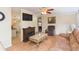 Comfortable living room featuring wood floors, a fireplace, and an open flow to the adjacent spaces at 36246 Peak St, Zephyrhills, FL 33541
