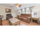 Cozy living room with plush seating, decorative tables, and natural light from the large front window at 36246 Peak St, Zephyrhills, FL 33541