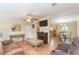 Inviting living room with wood floors, a fireplace, and an open layout connecting to the kitchen and dining area at 36246 Peak St, Zephyrhills, FL 33541
