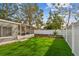Well-maintained backyard featuring a white privacy fence and access to the screened in back porch at 3907 Elkcam Se Blvd, St Petersburg, FL 33705