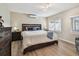 Bright bedroom with a king-size bed, wood floors, two windows letting in ample natural light, and a mini-split AC unit at 3907 Elkcam Se Blvd, St Petersburg, FL 33705