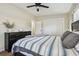 Comfortable bedroom featuring a ceiling fan, closet, and stylish striped bedding at 3907 Elkcam Se Blvd, St Petersburg, FL 33705