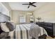 Bedroom with a ceiling fan and a comfortable bed with bedside tables and lamps. Natural light streams in through the windows at 3907 Elkcam Se Blvd, St Petersburg, FL 33705