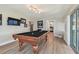 Spacious game room featuring a pool table, TV, and access to the kitchen and bedrooms at 3907 Elkcam Se Blvd, St Petersburg, FL 33705