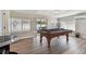Large game room with a pool table, natural light, and wood-look floors at 3907 Elkcam Se Blvd, St Petersburg, FL 33705