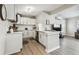 Bright kitchen features white cabinets, stainless steel appliances, and wood-look flooring at 3907 Elkcam Se Blvd, St Petersburg, FL 33705