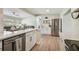 Open kitchen boasts quartz counters, stainless appliances, and a breakfast bar overlooking the living area at 3907 Elkcam Se Blvd, St Petersburg, FL 33705