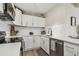 Stylish kitchen features white cabinets, stainless steel appliances, and tiled backsplash at 3907 Elkcam Se Blvd, St Petersburg, FL 33705